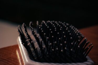 a close up of a hair brush on a table