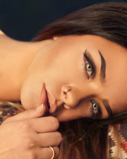 woman wearing red, white, and black aztec top